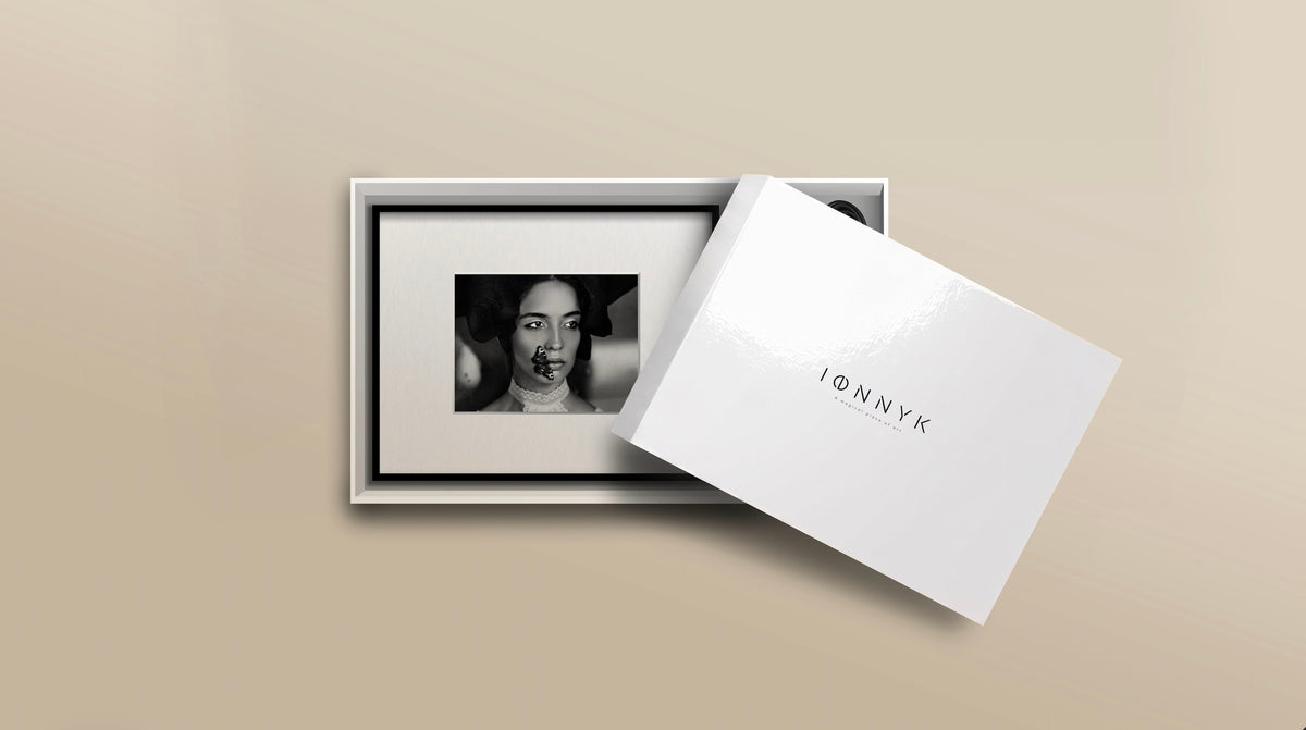 IONNYK digital art frame presented in its packaging with a black and white photograph displayed on the frame